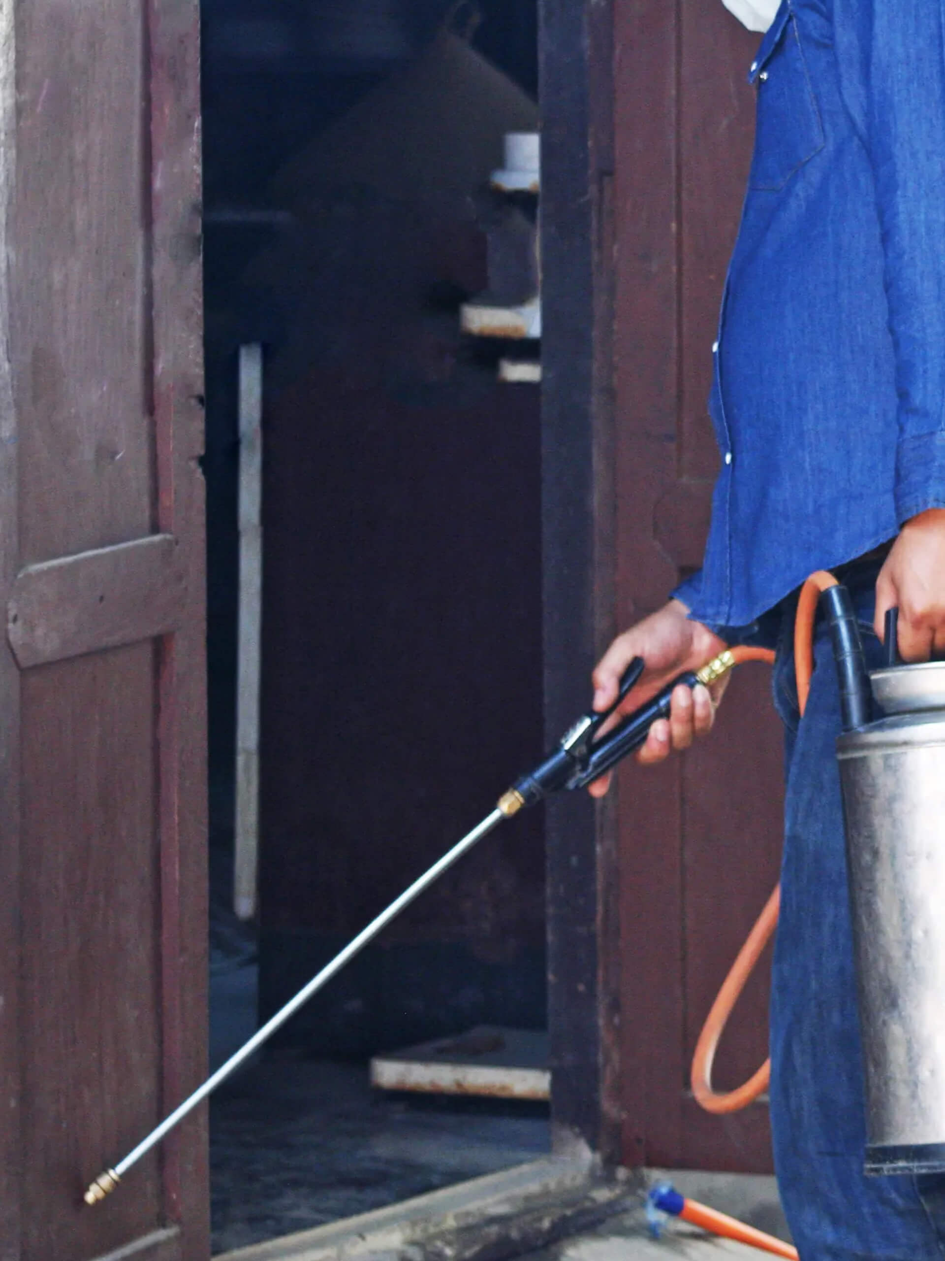 Pest control technician preparing to spray for pest management services in Douglasville, GA.